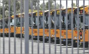  ?? AP FILE PHOTO/MATT YORK ?? SCHOOL BUSES ARE SECURED AT A FACILITY April 17, 2020, in Tempe. The Arizona House agreed Tuesday to allow school districts across Arizona to spend the money this academic year that they already have.