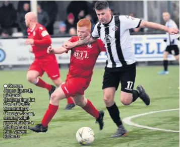  ??  ?? ● Steven Jones (in red), pictured challengin­g for the ball with Llandudno’s Gerwyn Jones, scored what proved to be a vital winner. Pic: Arwyn Roberts