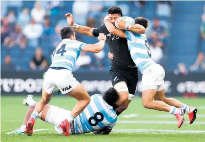  ?? Photo / Getty Images ?? All Black Ardie Savea is swamped by defenders in the test against Argentina at the weekend.