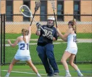  ?? PETE BANNAN — DIGITAL FIRST MEDIA ?? Great Valley’s Erin Kratzer (21) and Annie Stagnaro (19) try to block Rustin goalie Shenna Grady from clearing the ball.