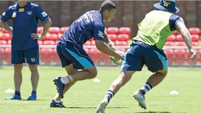  ?? PHOTO: KEVIN FARMER ?? STAR POWER: Gold Coast Titans player and Toowoomba product Ashley Taylor puts in the hard yards during an open training session at Clive Berghofer Stadium in December last year.