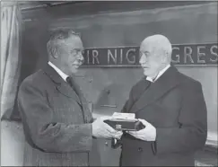  ??  ?? Gresley, left, is presented with a model of a train which was named after him in 1937. The engine itself is in the background