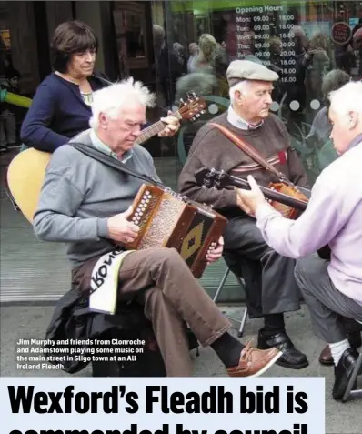  ??  ?? Jim Murphy and friends from Clonroche and Adamstown playing some music on the main street in Sligo town at an All Ireland Fleadh.