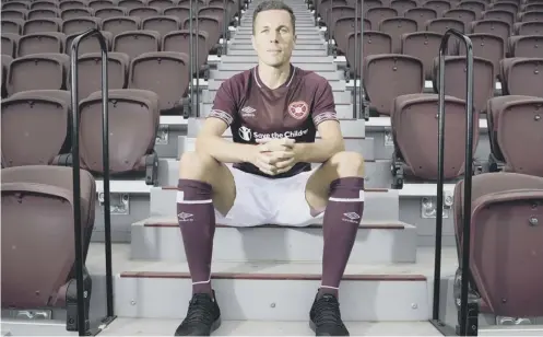  ??  ?? 0 Don Cowie, modelling Hearts’ new home kit yesterday, felt the players weren’t pushed hard enough under Ian Cathro last summer.