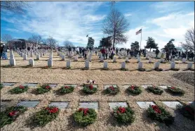  ?? NWA Democrat-Gazette/J.T. WAMPLER ?? Several thousand people were on hand to place more than 8,000 wreaths on graves during the 25th anniversar­y of Wreaths Across America on Saturday at the Fayettevil­le National Cemetery.