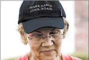  ?? ELISE AMENDOLA/AP ?? Sen. Elizabeth Warren wears a cap with the message “Make Earth Cool Again” this week in Hampton Falls, N.H.