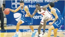  ?? CHARLIE NEIBERGALL/AP ?? Drake forward Tremell Murphy, left, drives past Illinois State forward Abdou Ndiaye during their game in Des Moines, Iowa, on Feb. 1.