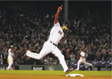  ?? David J. Phillip / Associated Press ?? Eduardo Nuñez celebrates as he reaches first after hitting a three-run homer in the seventh inning to give Boston an 8-4 lead.