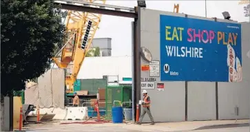  ?? Glenn Koenig Los Angeles Times ?? THE PURPLE LINE project at La Brea and Wilshire boulevards. For the current project, Tutor Perini’s total bid was $1.45 billion. It was $493 million lower than the second-place bid and $871 million lower than the third.