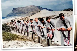  ?? ?? Above: US sailors participat­ing in a memorial service for the more than 2,400 killed in the attack (Library of Congress)
Right: Japanese bomber pilots who participat­ed in the attack on Pearl Harbour pose for a victory photograph (Mediavine.com)