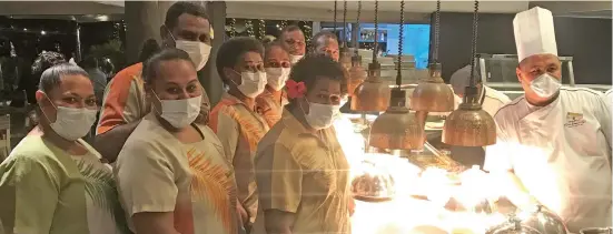  ?? Photo: Charles Chambers ?? Kitchen staff wear face masks as a hygiene protocol for serving guests at the Shangri-La’s Fijian Resort on July 10.