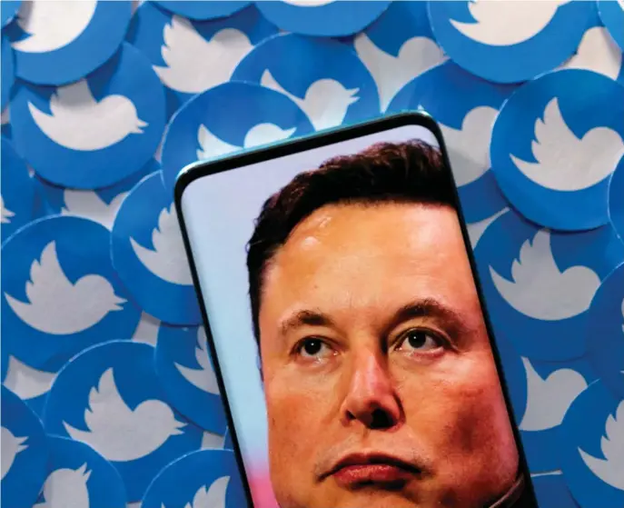  ?? ?? FILE PHOTO: Illustrati­on shows Elon Musk image on smartphone and printed Twitter logos. Image: Reuters/Dado Ruvic