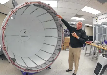  ?? Steve Gonzales / Houston Chronicle ?? NanoRacks project manager Brock Howe uses a full-scale model to demonstrat­e how a commercial airlock system will work.