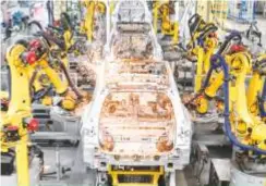  ?? ?? Robots weld bodyshells of cars at a workshop of Chinese electric vehicle (EV) maker Li Auto Inc. in Changzhou, east China’s Jiangsu Province.
