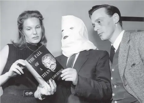  ??  ?? Igor Gouzenko on TV in 1954 with actors from the film of his book, Fall of a Titan, which won the Governor General’s Award for fiction the same year.
Gouzenko wore the hood for media appearance­s to protect the identity of his family.