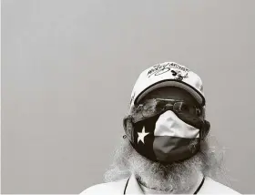  ?? Jason Fochtman / Staff photograph­er ?? A man wears a Texas-themed face mask during the UIL State Swimming & Diving Championsh­ips on Monday in San Antonio.