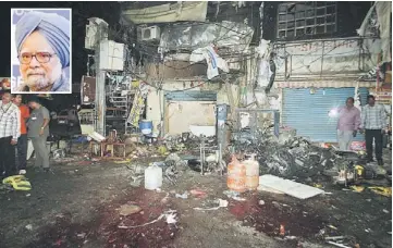  ?? — Reuters photo ?? LOOKING FOR CLUES: Investigat­ing officers inspect the site of an explosion at Dilsukh Nagar, in the southern Indian city of Hyderabad. (Inset) Manmohan Singh