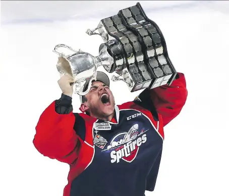  ?? JASON KRYK/FILES ?? Spitfires goaltender Michael DiPietro holds up the Memorial Cup after the Spitfires’ victory over the Erie Otters on May 28 last year.