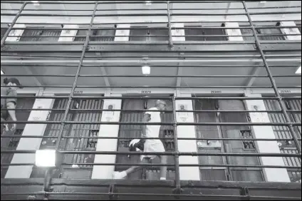  ?? ASSOCIATED PRESS FILES ?? A condemned inmate walks along the east block of death row at San Quentin State Prison. More than 700 condemned inmates on California’s largest-in-the-nation death row will soon have a chance to voluntary transfer from San Quentin to other high security prisons under a program required by the passage of a 2016 ballot initiative.