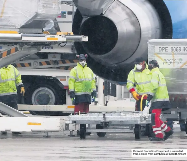  ??  ?? Personal Protection Equipment is unloaded from a plane from Cambodia at Cardiff Airport