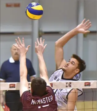  ?? JOHN RENNISON, THE HAMILTON SPECTATOR ?? Long Beach State 49ers’ TJ DeFalco spikes the volleyball against Marauders’ Matt Passalent’s block during a game Saturday night at McMaster University. Mac won the five-set match 3-2, a night after winning in four.