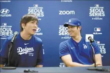  ?? AP file photo ?? The Dodgers’ Shohei Ohtani (right) and his interprete­r, Ippei Mizuhara, attend a news conference Saturday in South Korea. Mizuhara, who is being criminally investigat­ed by the IRS, was fired by the Dodgers on Wednesday.