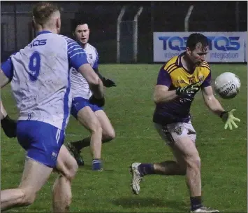  ??  ?? First-half goalscorer Ben Brosnan about to claim possession after the break as Michael Kiely moves in.