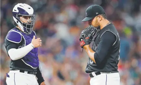  ?? David Zalubowski, The Associated Press ?? Colorado relief pitcher Carlos Estevez waits to be pulled from the mound, next to catcher Tony Wolters, after issuing a walk to San Francisco’s Brandon Belt during the eighth inning Saturday at Coors Field.