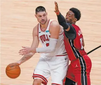 ?? AP PHOTOS ?? TOP: Even coach Billy Donovan (left, with White) will need to be conscious of impressing the boss as the Bulls aim to end a four-year playoff drought. ABOVE: Nikola Vucevic helps the Bulls’ chances considerab­ly.