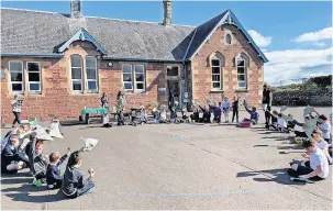  ?? ?? Great achievemen­t The school held a small celebratio­n in the playground on Thursday last week