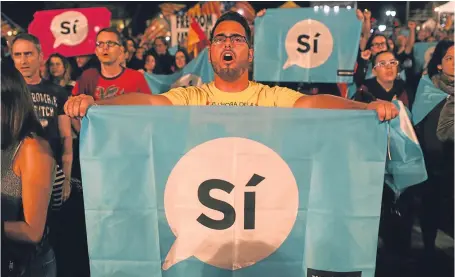  ?? Pictures: Getty. ?? Crowds listen to Catalan President Carles Puigdemont speak via a televised press conference as they await the result of the independen­ce referendum at the Placa de Catalunya last night.