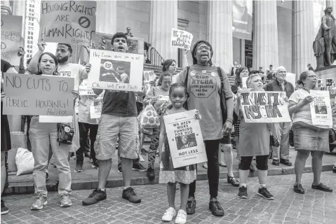  ?? Erik McGregor/Sipa USA/TNS ?? ■ Members of Community Voices Heard protest on Jun 12, 2017, outside the New York Stock Exchange in hopes of meeting with Secretary Ben Carson about proposed HUD cuts.