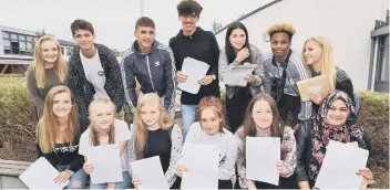 ??  ?? Students at St John Fisher with their GCSE results