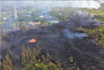  ?? U.S. Geological Survey ?? An aerial view shows lava erupting Saturday from a fissure in the Leilani Estates district near the town of Pahoa. More than two dozen homes have been destroyed over the past week.