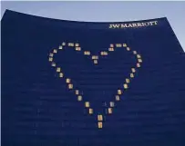  ?? Associated Press file photo ?? The outline of a heart shines on a JW Marriott in Indianapol­is in April. The company is among those halting donations to Republican­s who opposed certifying Joe Biden’s election.