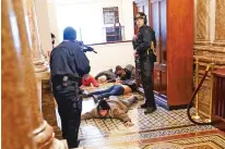  ?? ANDREW HARNIK/ASSOCIATED PRESS ?? U.S. Capitol Police hold protesters at gunpoint near the House Chamber inside the Capitol.