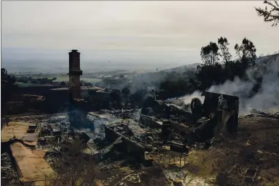  ?? DAVID ROYAL — MONTEREY HERALD CORRESPOND­ENT ?? A burned home smolders as the River Fire burns in Pine Canyon in rural Salinas last month.