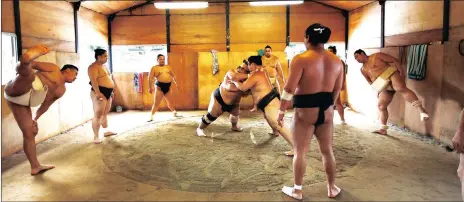  ?? Pictures: REUTERS ?? CLASH: The Tomozuna stable wrestlers put in a tough training session.