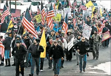  ?? LES ZAITZ/OREGONIAN PHOTOS ?? Protesters march in Burns, Ore., on Saturday in support of local ranchers ordered to prison for burning federal lands.