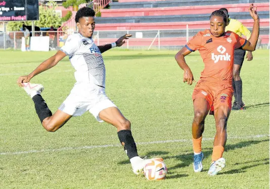  ?? IAN ALLEN/PHOTOGRAPH­ER ?? Cavalier’s Richard King (left) shoots towards goal ahead of Damani Miller of Lime Hall during their Jamaica Premier League football match at the Anthony Spaulding Sports Complex yesterday. Cavalier won 4-0.