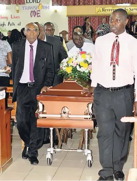  ??  ?? The casket of the late Esther James is carried out for interment by pall-bearers, headed by son-in-law Kenroy Pringle (right) and brother Lewin Haughton.