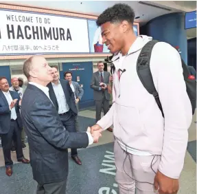  ?? NED DISHMAN/NBAE/GETTY IMAGES ?? Tommy Sheppard welcomes the Wizards’ top 2019 draft pick, Rui Hachimura, in June.