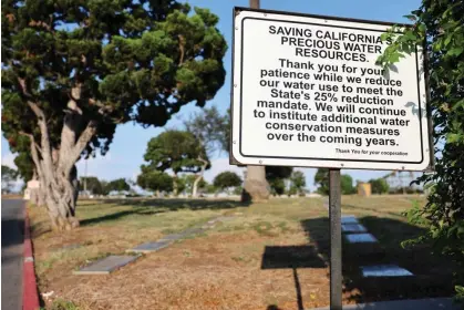  ?? Mario Tama/Getty Images ?? A sign is posted about water reduction at Calvary Cemetery in Los Angeles, California, amid the state’s ongoing record drought. Photograph: