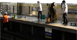  ?? PHOTOGRAPH COURTESY OF PNA ?? THE three-day MRT shutdown allows workers to clean and disinfect stations before the trains start running again.