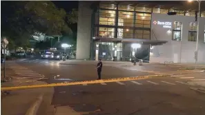  ?? The Sentinel-Record/Andrew Mobley ?? ■ Crime scene tape surrounds the scene at the intersecti­on of Convention Boulevard and Laurel Street, outside the Hot Springs Convention Center, Thursday night in the aftermath of a shooting where four people were injured by gunfire, with one victim later dying.