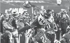  ?? BILL STREICHER/USA TODAY SPORTS ?? Seahawks receiver DK Metcalf attempts to leap over Eagles cornerback Darius Slay. He had 10 receptions for 177 yards Monday.