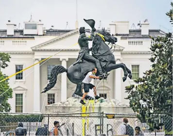  ??  ?? Protesters attempt to pull down the statue of the seventh US president Andrew Jackson in Lafayette Square near the White House