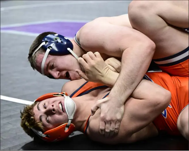  ?? ANDY CROSS — THE DENVER POST ?? Quinn Funk of Legacy High, top, wrestles Nathan Sandy of Legend High in the Class 5A 215- pound semifinals during the CHSAA state tournament at Ball Arena on Friday.