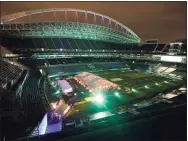  ?? Ted S. Warren / Associated Press ?? People eat dinner in an outdoor dining tent set up at Lumen Field, home of the Seahawks.