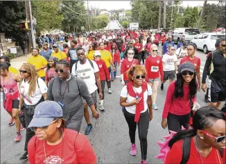  ?? STEVE SCHAEFER / SPECIAL TO THE AJC ?? Walkers head up 10th Street at the beginning of the 27th annual AIDS Walk Atlanta & 5K Run on Sunday at Piedmont Park in Atlanta.